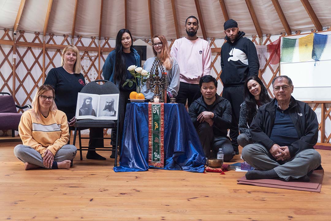 a gathering of people posing for a photo in a retreat center while on a retreat