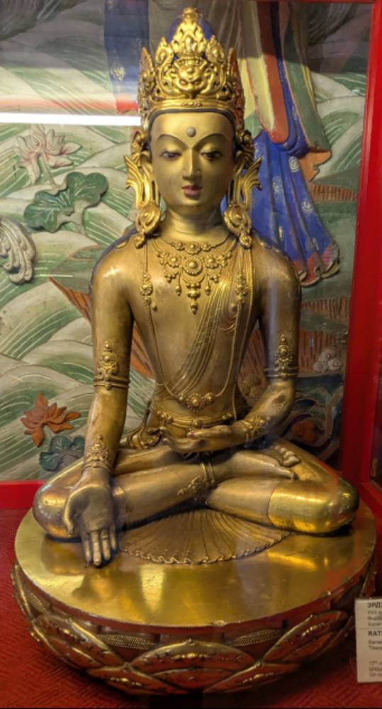 Golden statue of Ratnasambhava Buddha seated in a meditation pose.