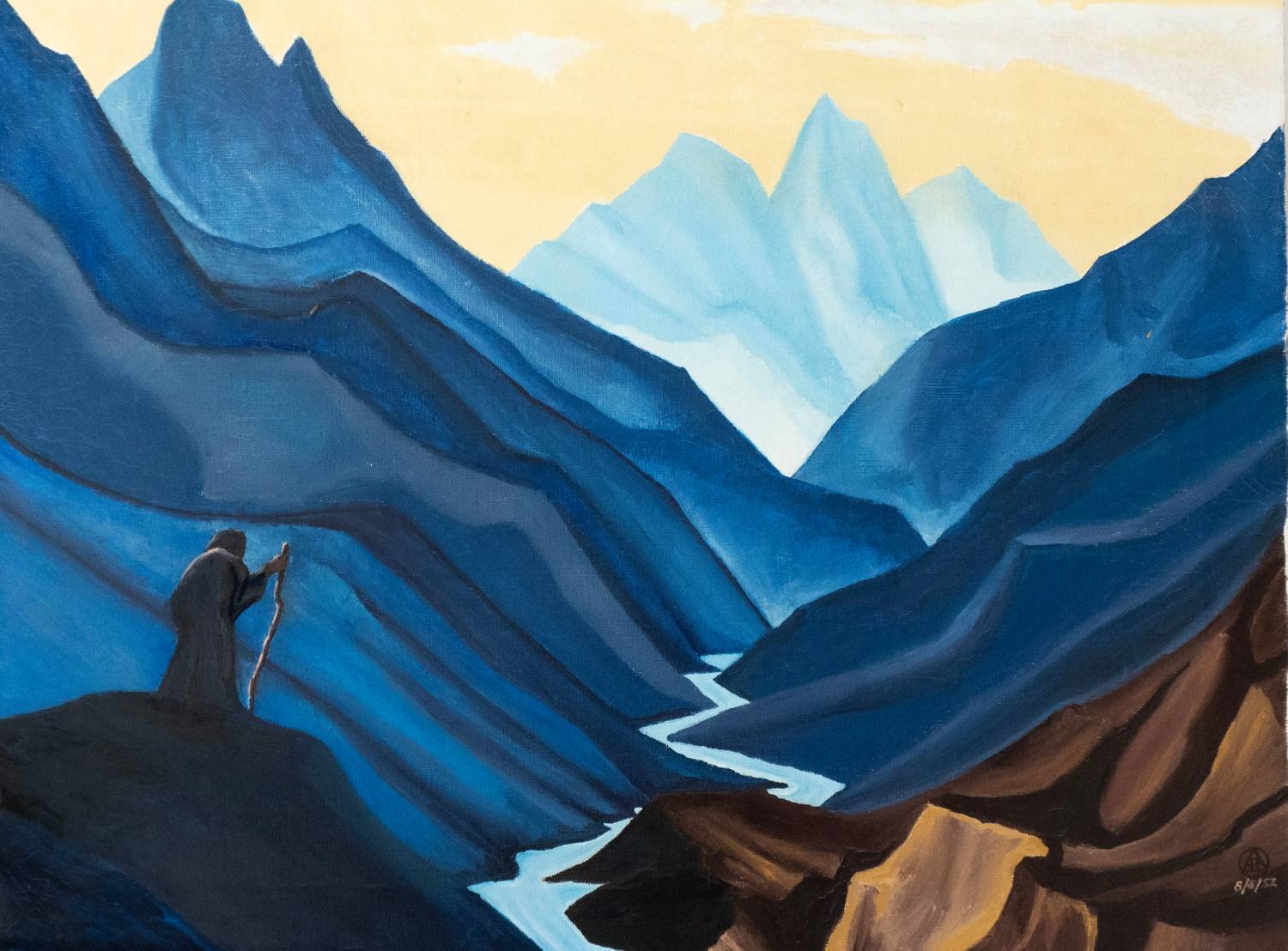 a man holding a staff looking down a valley with a river